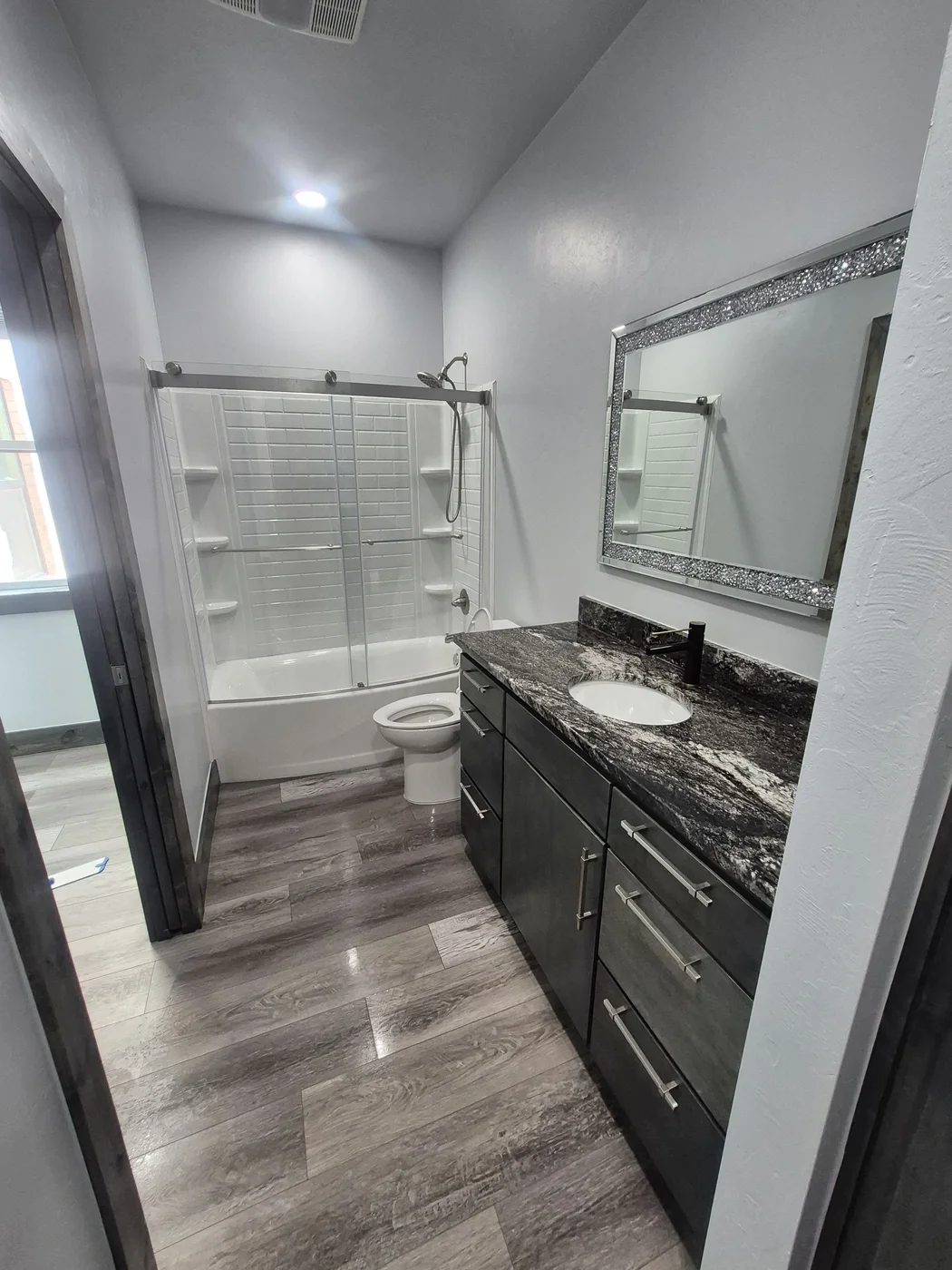 Bathroom after a deep clean — tub, vanity, and mirror