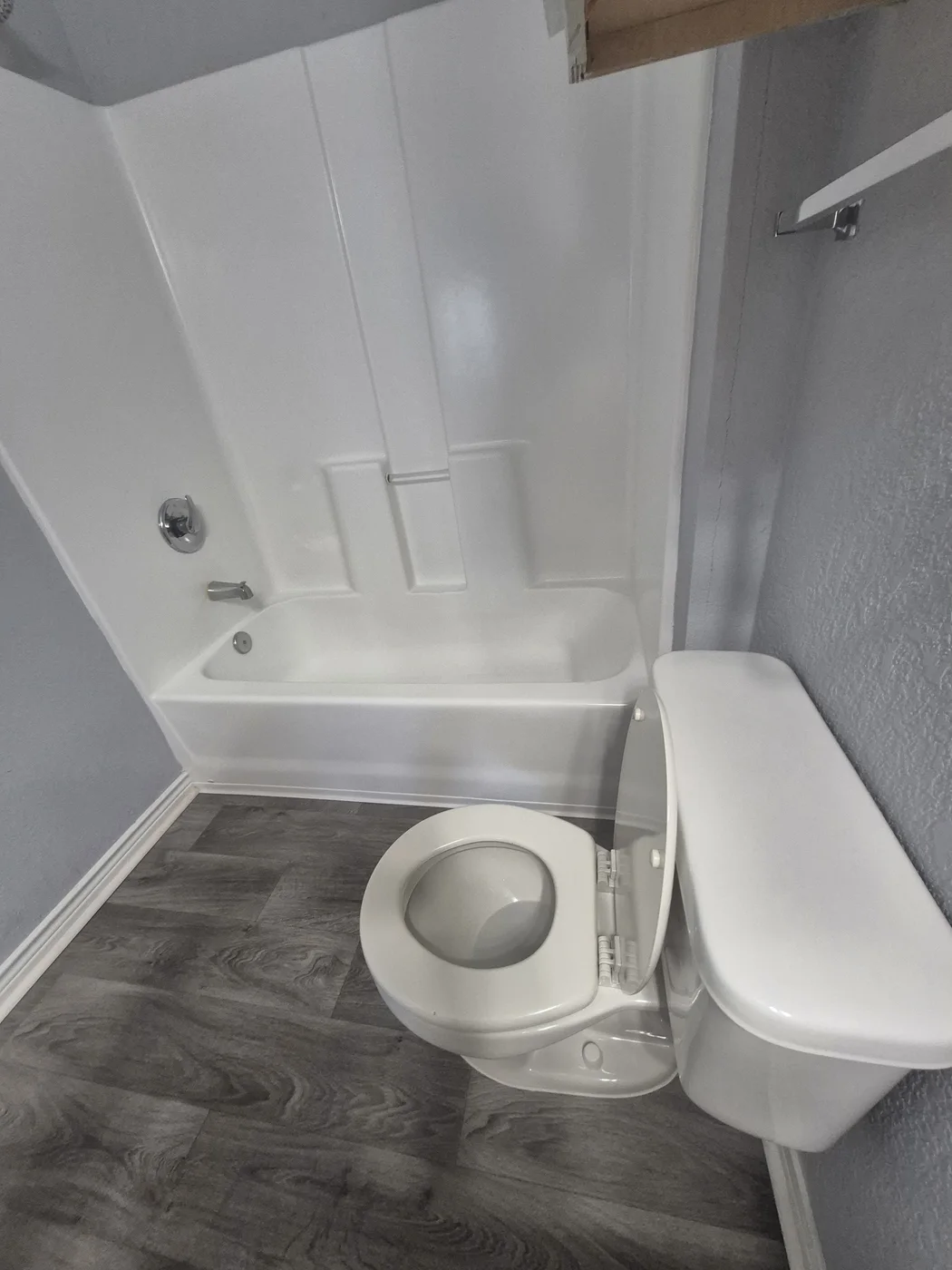 Toilet, tub, and tile floor after cleaning